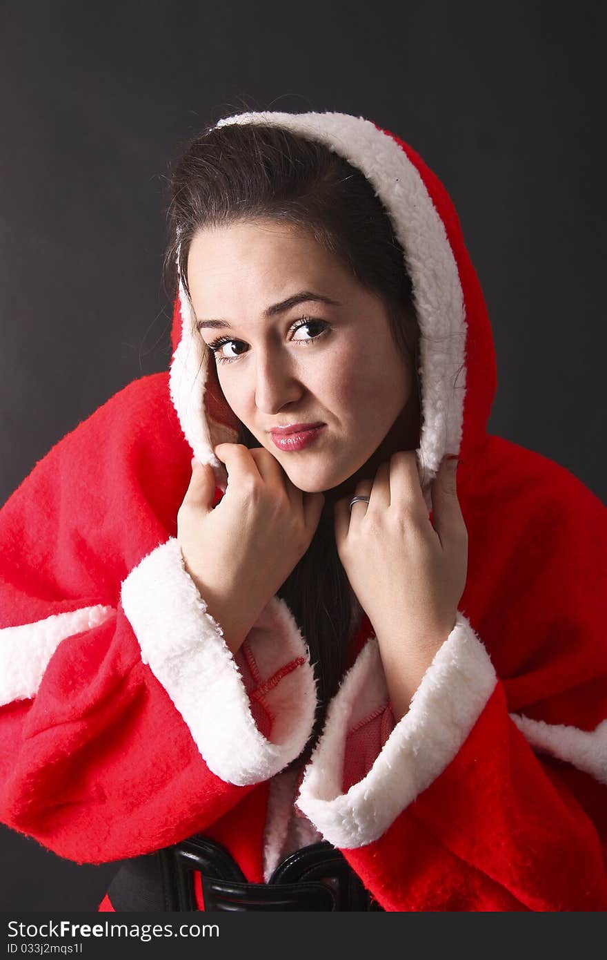 Portrait of a beautiful girl Santa,close-up.black background