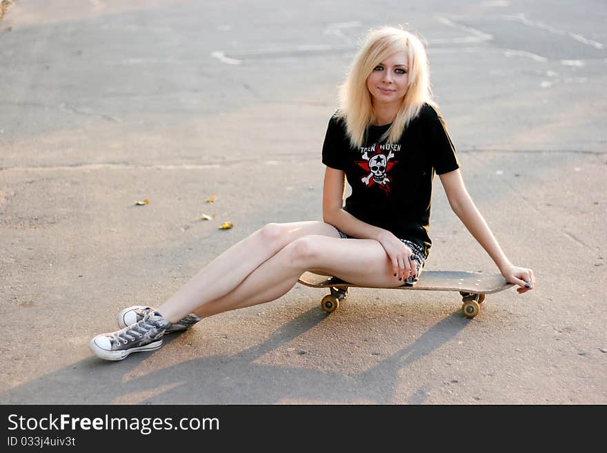 Young caucasian teen with skate on the street