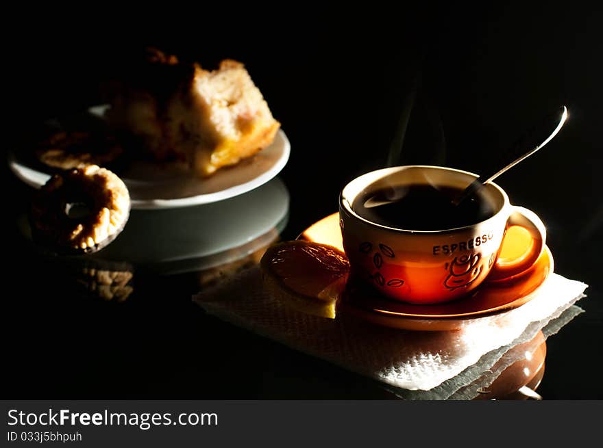 Cup of coffee and saucer with a cake