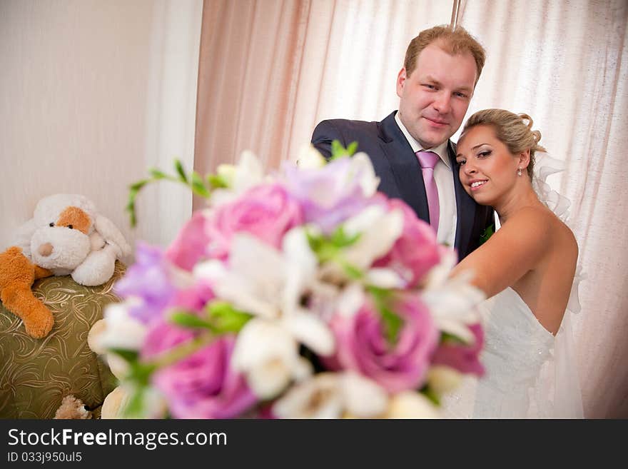 Bride and groom with a flower bouquet. Bride and groom with a flower bouquet