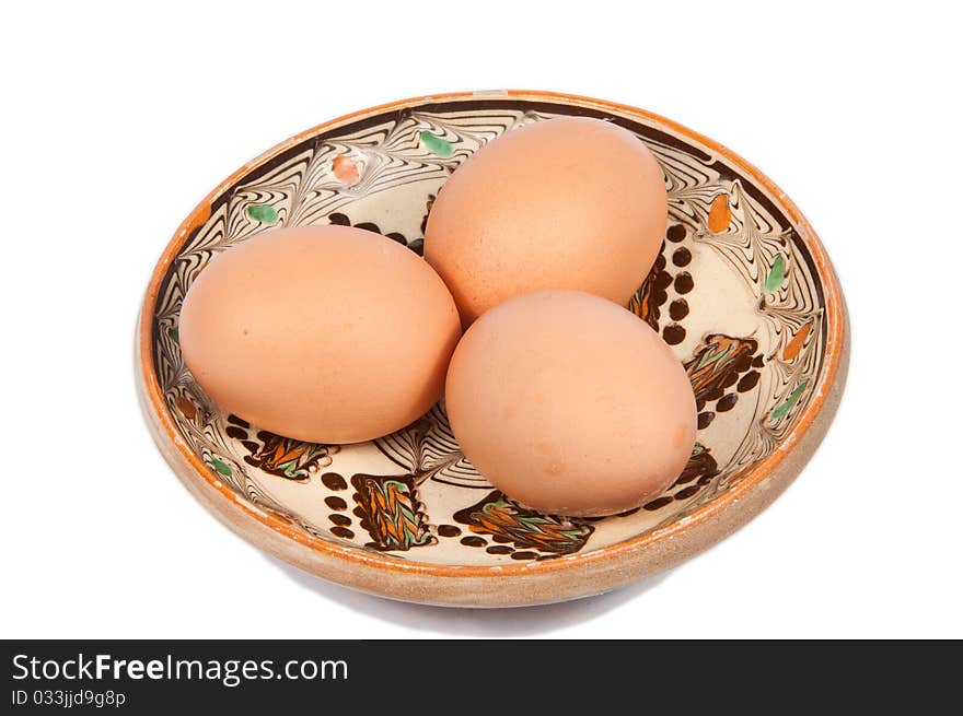 Three eggs on a traditional plate