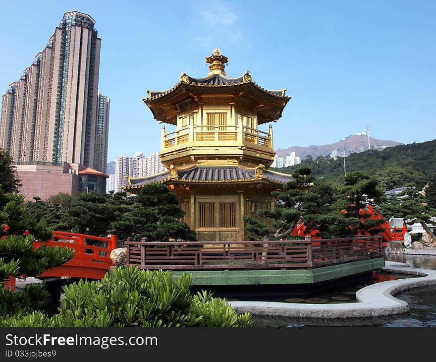 Small Chinese home in the garden and skyscraper. Small Chinese home in the garden and skyscraper