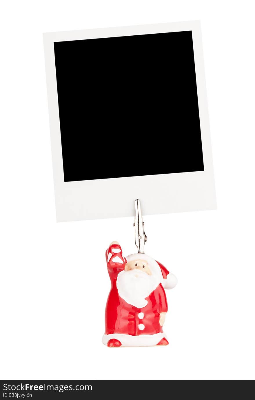 Photo holder in the form of Santa Claus with polaroid card isolated on a white background. Photo holder in the form of Santa Claus with polaroid card isolated on a white background.