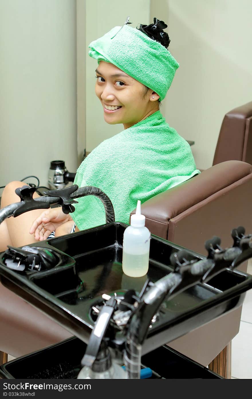 Happy Asian ethnic young woman having hair spa treatment at hairdressing salon. Happy Asian ethnic young woman having hair spa treatment at hairdressing salon