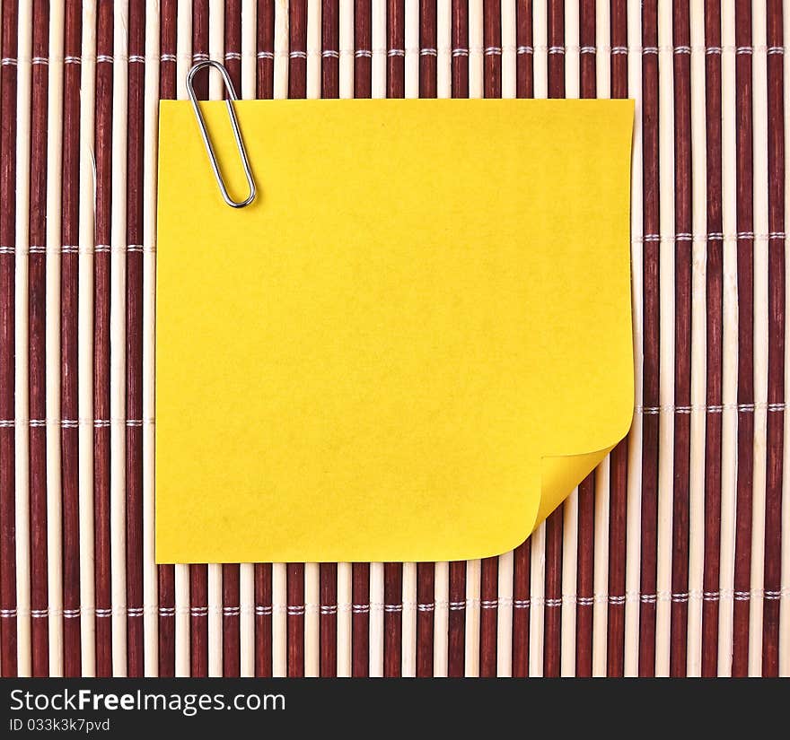 Yellow note and clip on mat. Yellow note and clip on mat