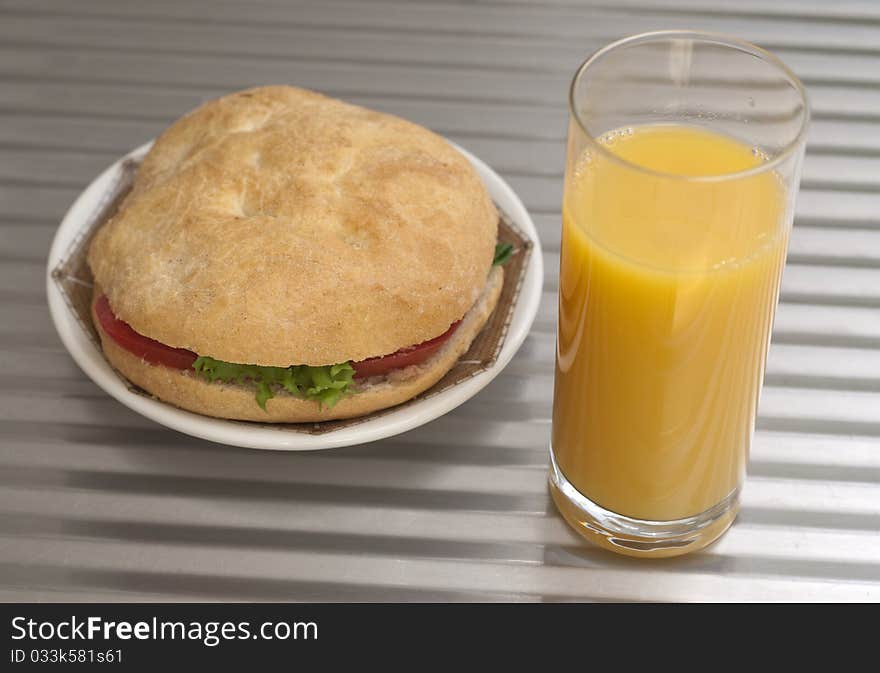 Delicious sandwich and a glass of orange juice. Delicious sandwich and a glass of orange juice