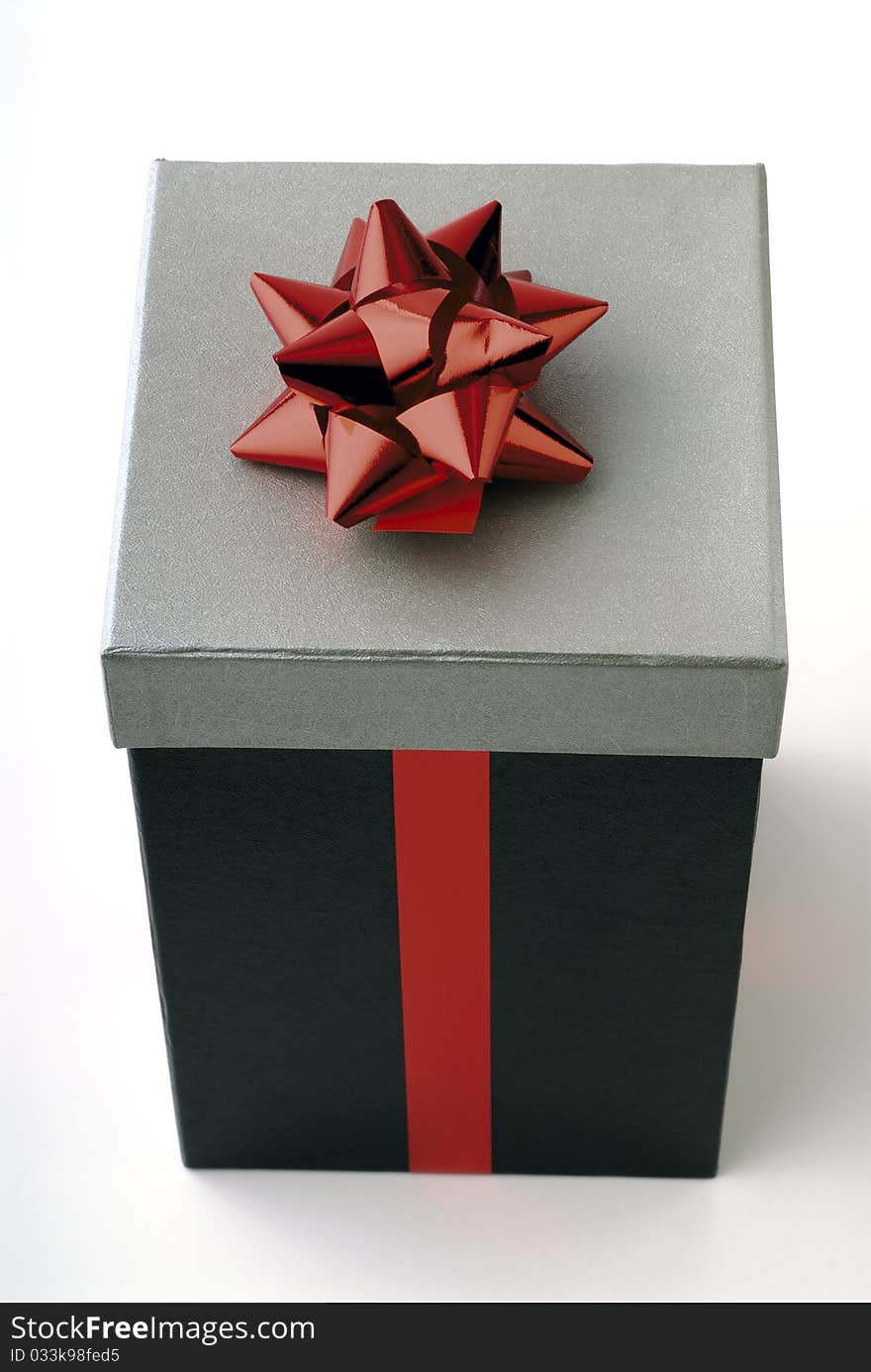 Gift in a box with red ribbon