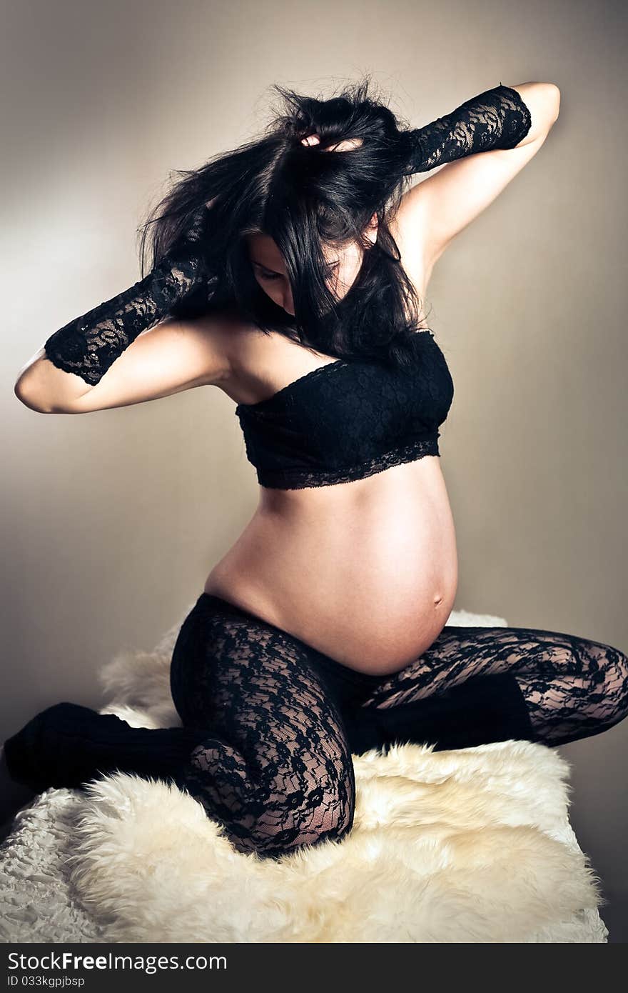 Pregnant woman in lacy stockings