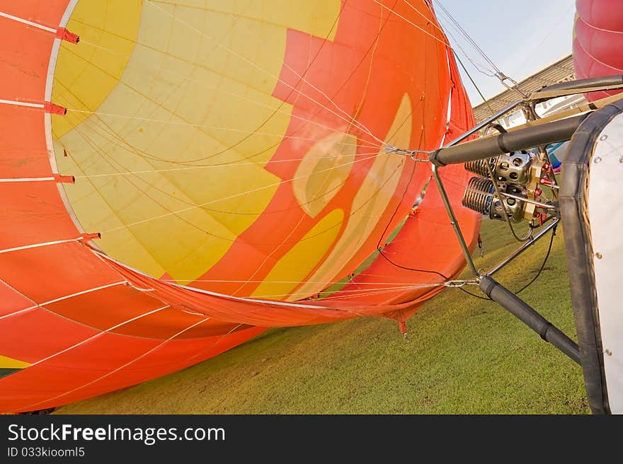 Yellow and orange hot air balloon on grass. Yellow and orange hot air balloon on grass.