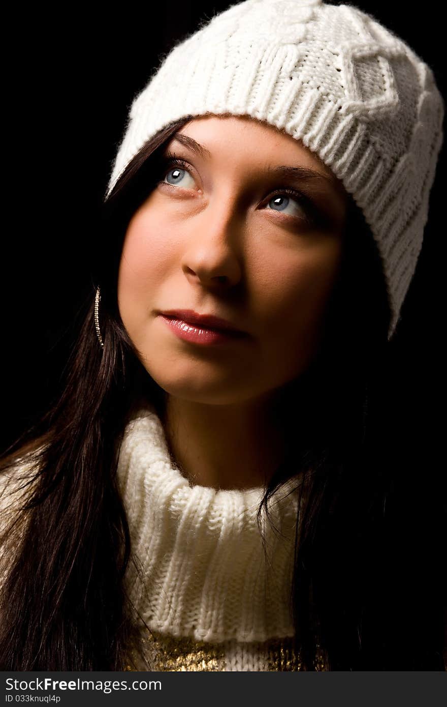 Photo of woman with white winter hat on black background. Photo of woman with white winter hat on black background