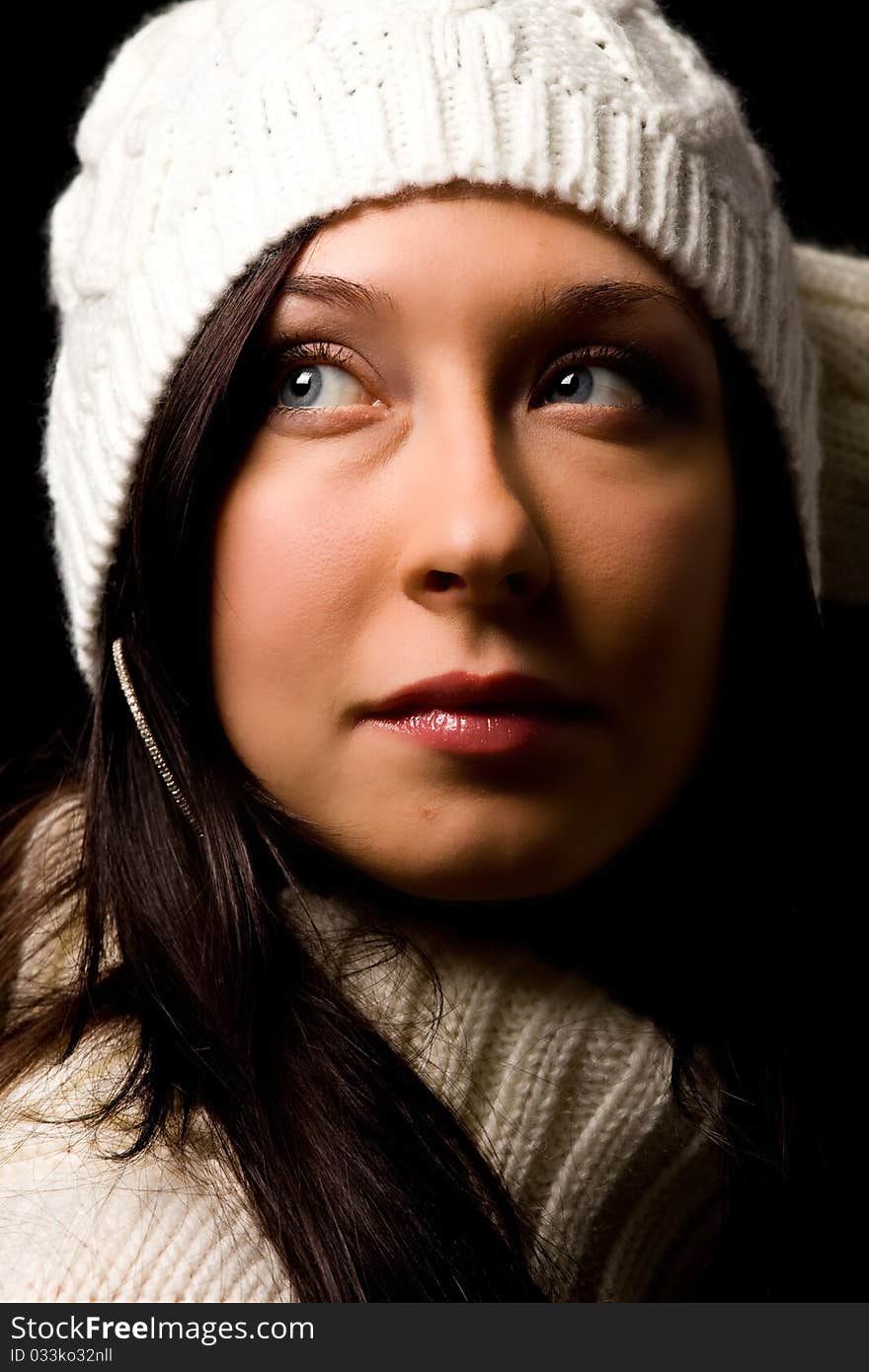 Photo of woman with white winter hat on black background. Photo of woman with white winter hat on black background