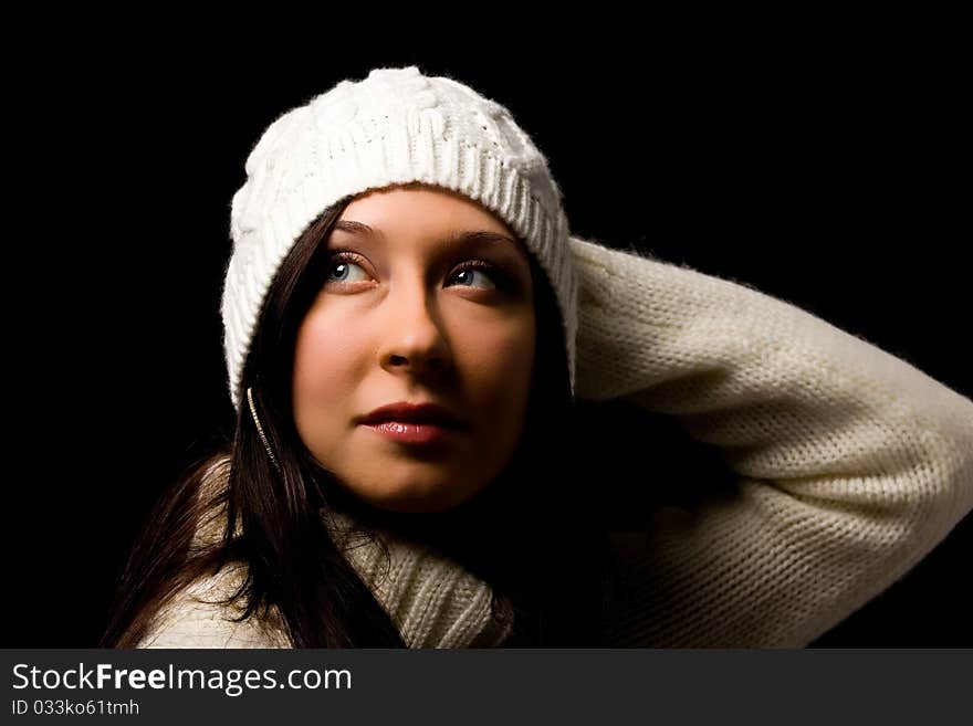 Photo of woman with white winter hat on black background. Photo of woman with white winter hat on black background