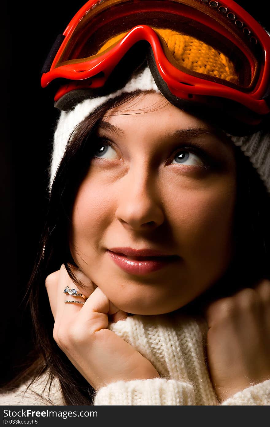 Photo of cute woman with snowboard mask on black background