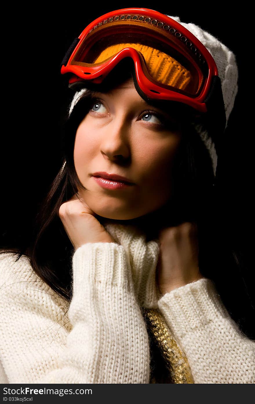 Photo of cute woman with snowboard mask on black background