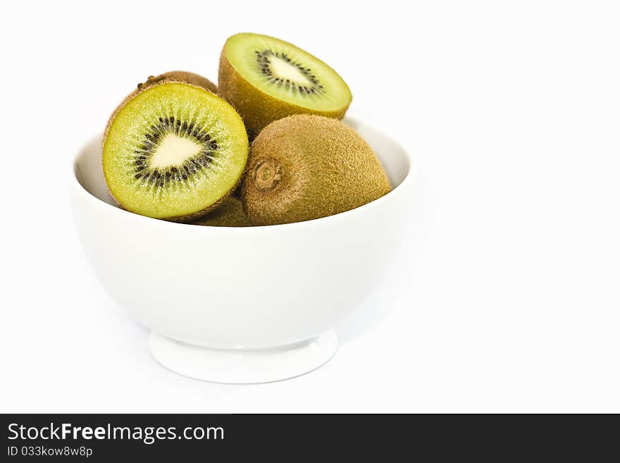 Kiwi fruit in white bowl isolated on white background.