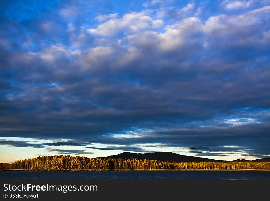 Sunset under the lake and forest