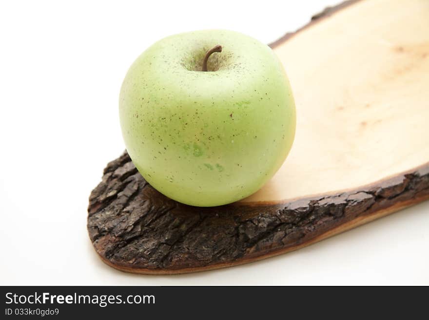 Apple on wood with bark