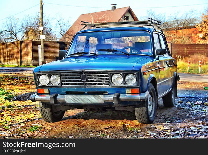 Russian old car Lada VAZ-2106 in HDR with country house on background. Russian old car Lada VAZ-2106 in HDR with country house on background.