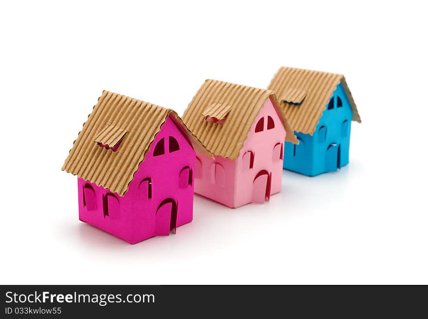 Three color paper small houses on a white background. Three color paper small houses on a white background