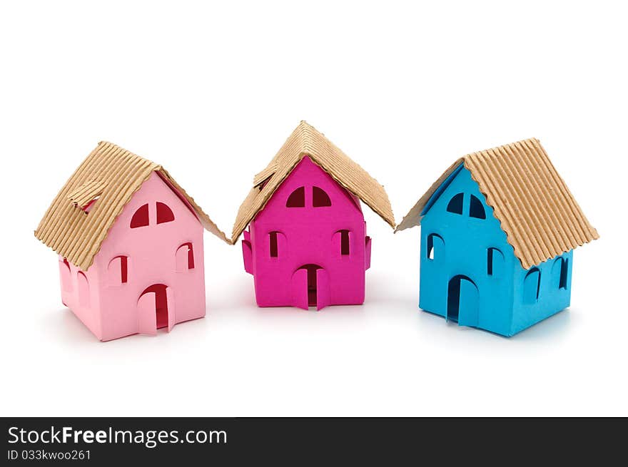 Three color paper small houses on a white background. Three color paper small houses on a white background