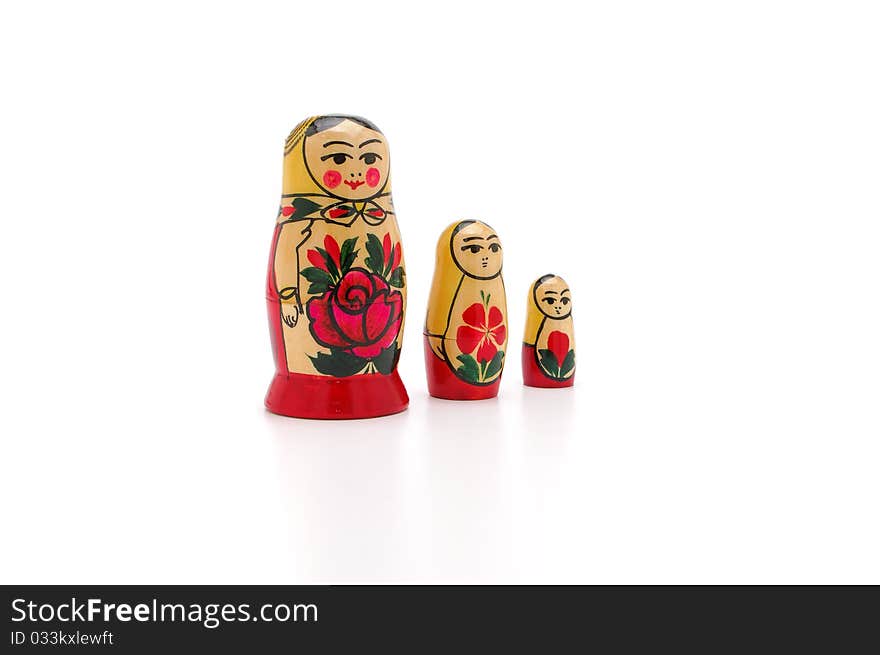 Three dolls of various sizes on a white background