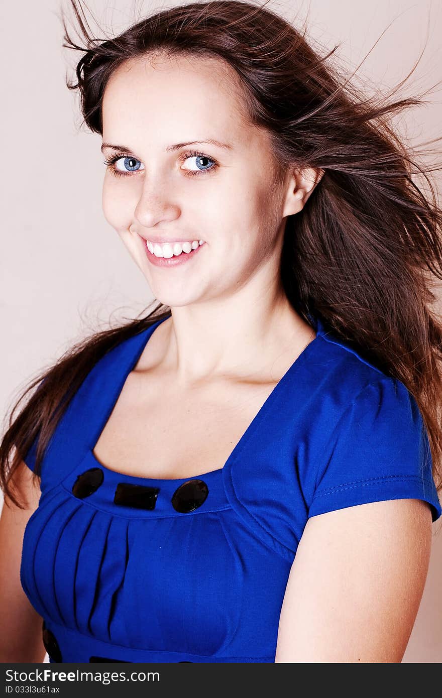 Beauty young woman in blue dress with blue eyes