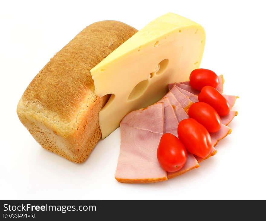 Piece of yellow cheese with a piece of meat and tomatoes on a white background. Piece of yellow cheese with a piece of meat and tomatoes on a white background