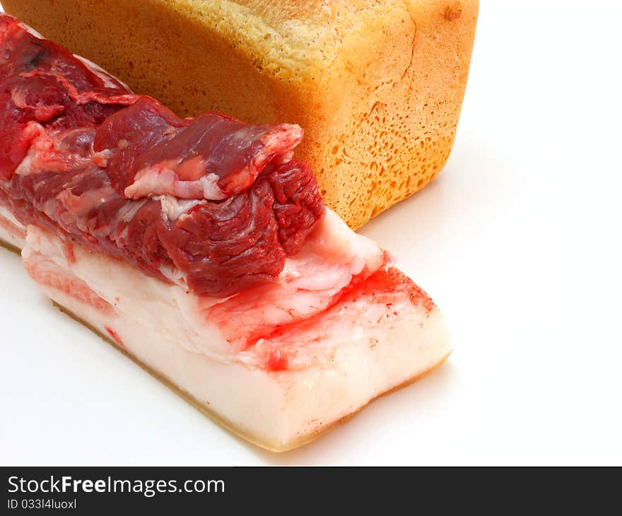 Bread and the big piece of meat on a white background