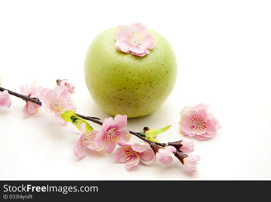 Green apple with blossom