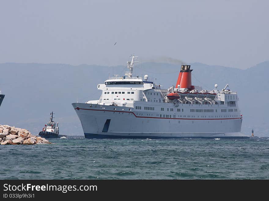 Passenger and car ferry under tow from a tug boat, Cesme, Turkey. Passenger and car ferry under tow from a tug boat, Cesme, Turkey.