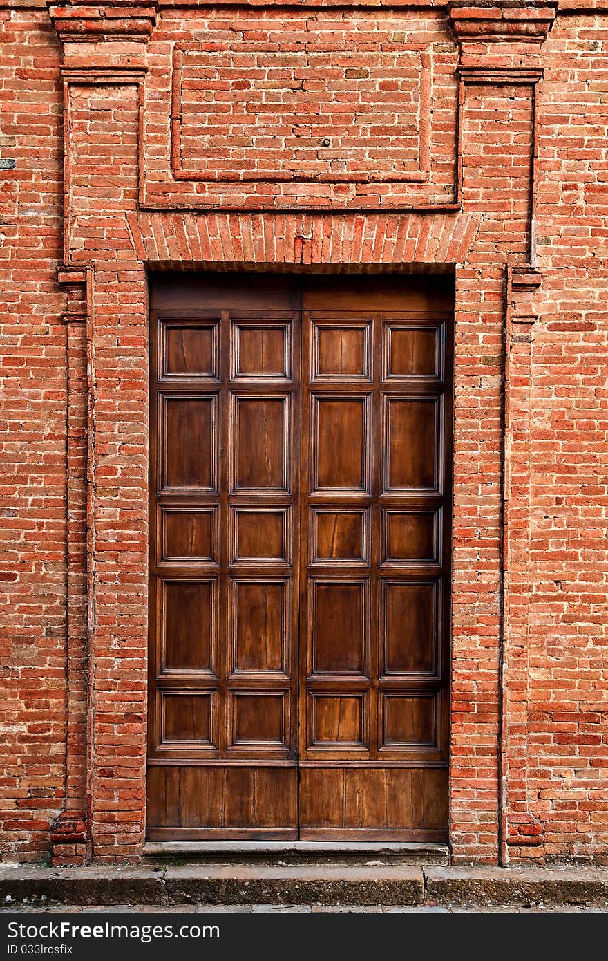 Antique tuscan door in Pienza, Italy.