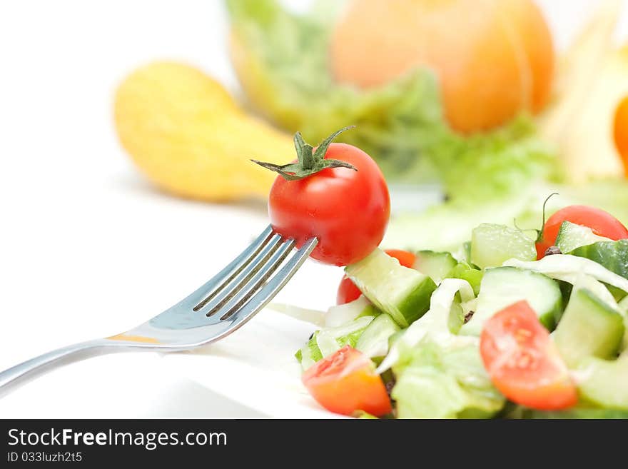 Tomato cherry and fork on white background. Tomato cherry and fork on white background.