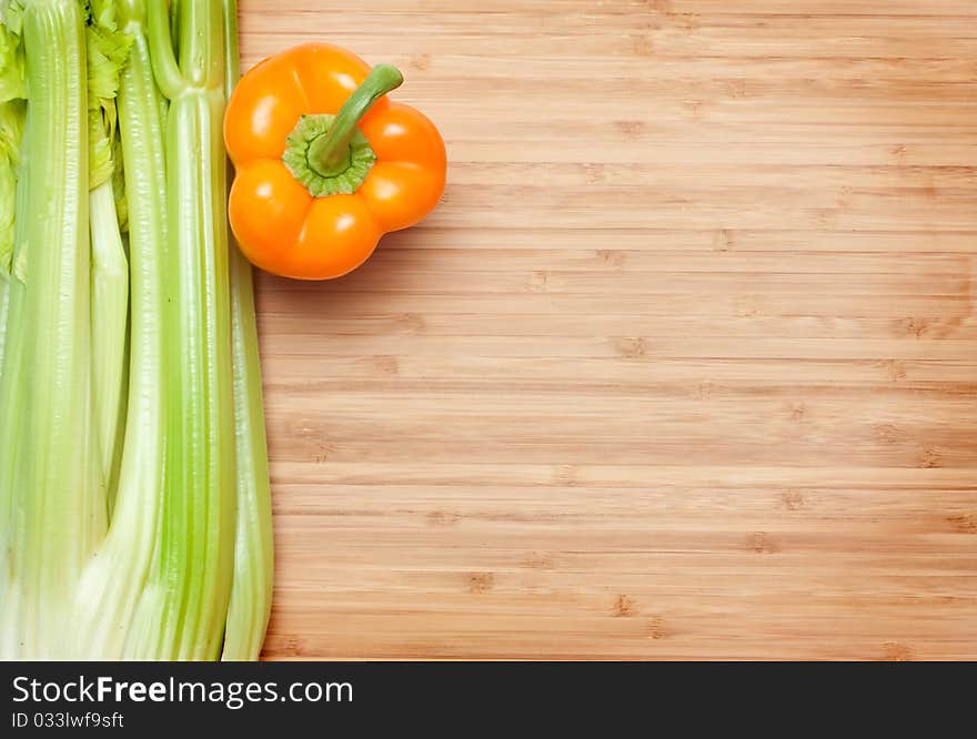 Orange pepper. green salad on cutting board. Orange pepper. green salad on cutting board