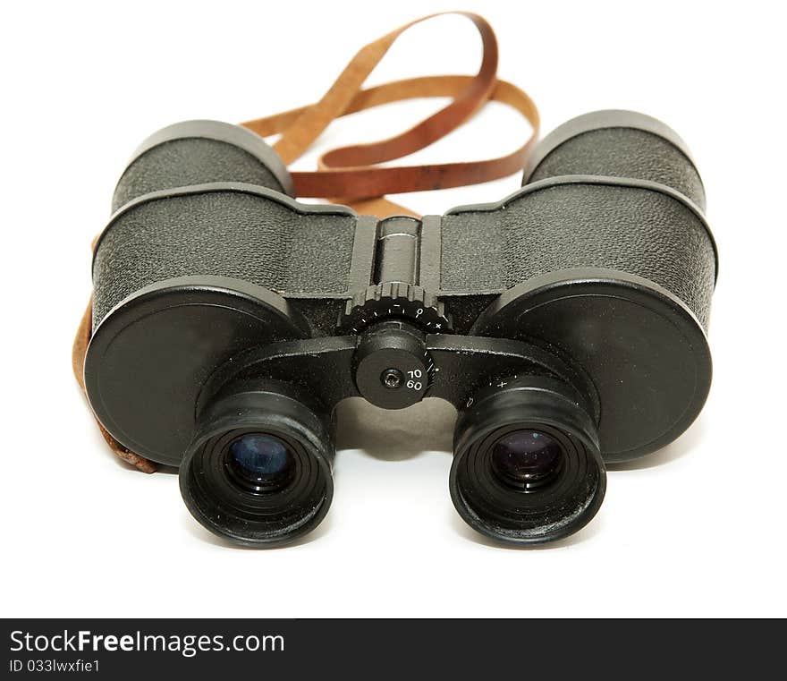 Old black glasses with a leather strap on a white background