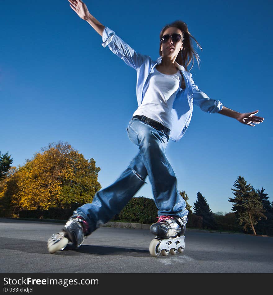 Wide-angle shot of a sliding rollerskater - motion blur on person. Wide-angle shot of a sliding rollerskater - motion blur on person