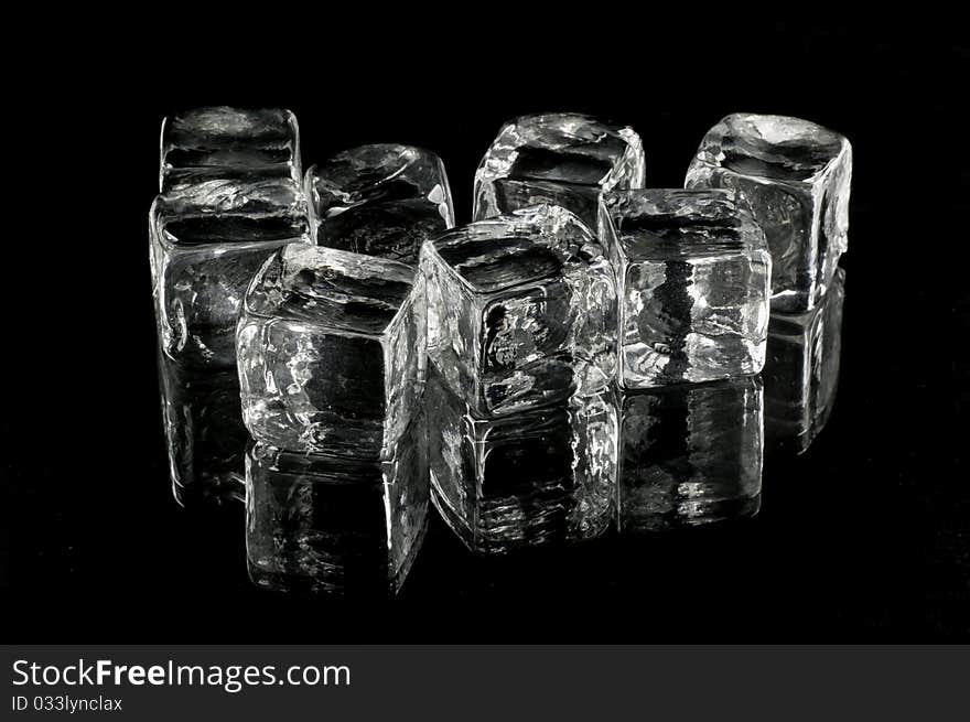 Glass cubes on black background with reflections.