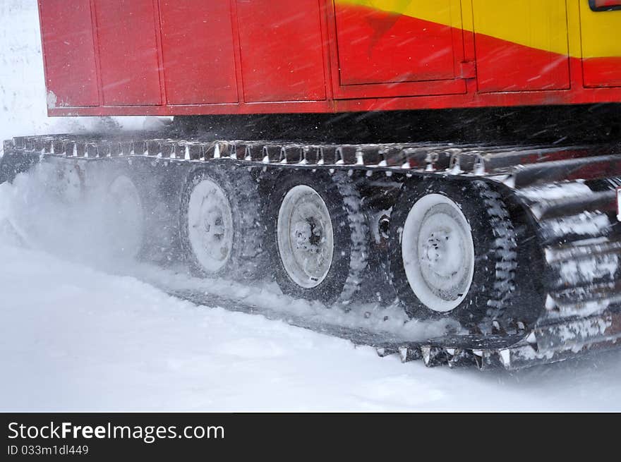 A marching tractor goes in the snowstorm. A marching tractor goes in the snowstorm