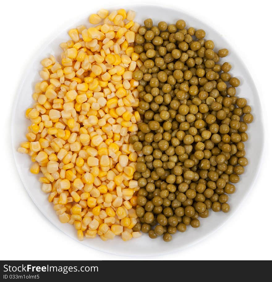 Corn and peas on a plate on a white background