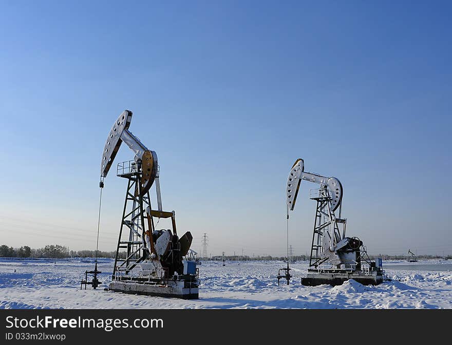 Cold winter, oil producing equipment is covered with snow. Cold winter, oil producing equipment is covered with snow