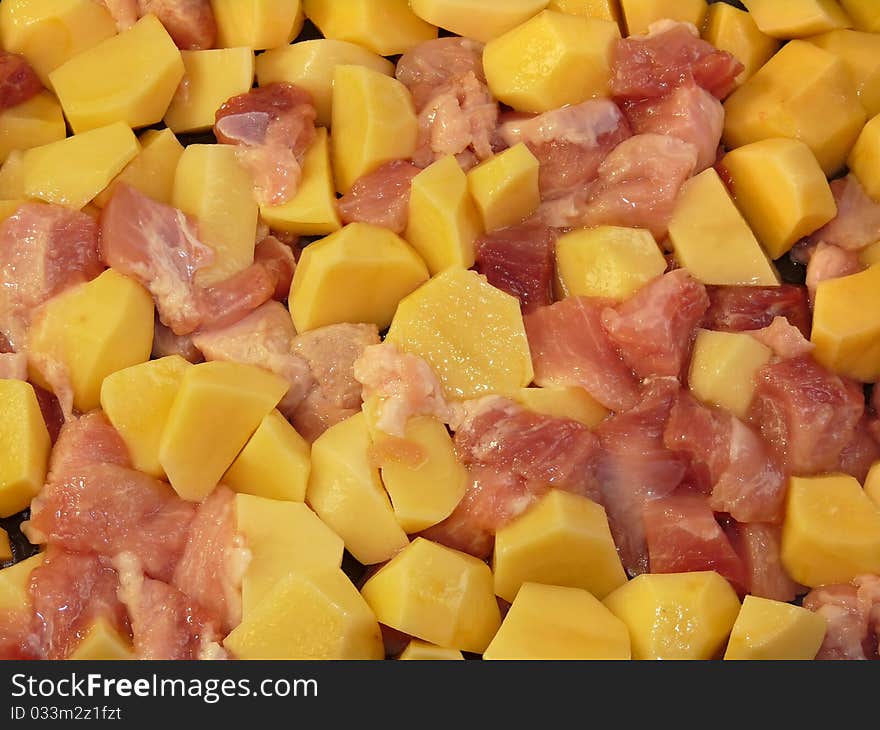 Meat and potatoes in trays, isolated on a white background