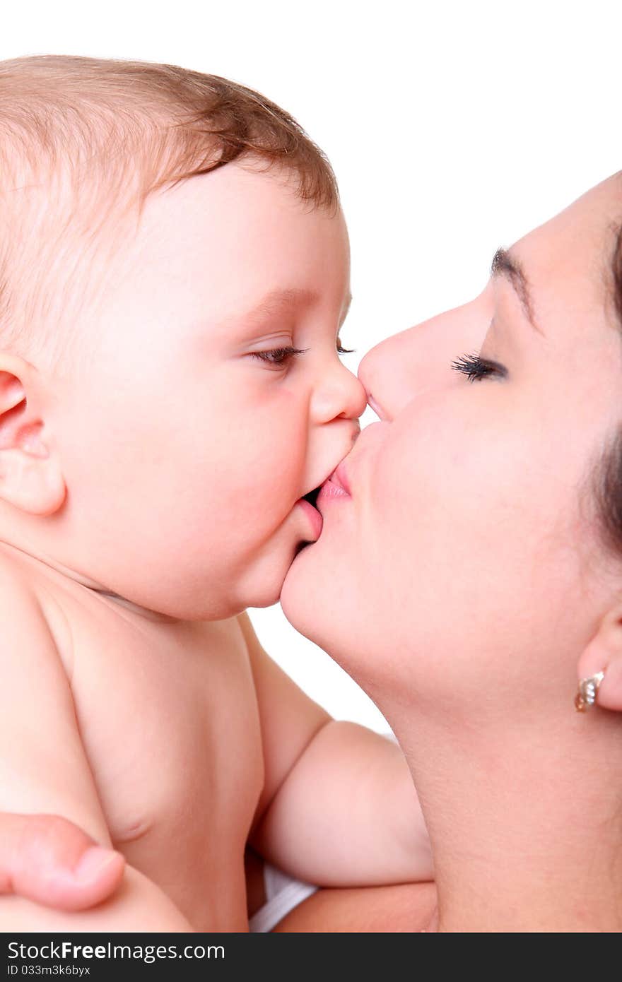 Happy young mother kissing a baby isolated on white