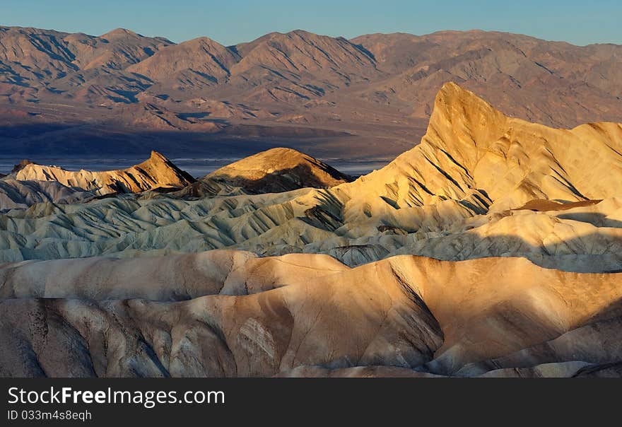 Zabriske badlands and Manly Beacon at sunrise from Zabriske Point in Death Valley National Park, California