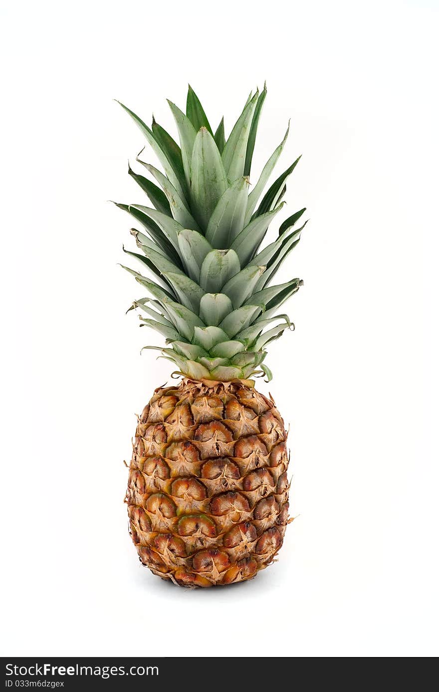 Ripe pineapple on a white background isolated. Ripe pineapple on a white background isolated