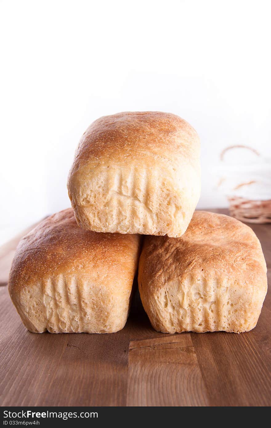 Three loaf of fresh cooking bread on the wooden desk. Three loaf of fresh cooking bread on the wooden desk