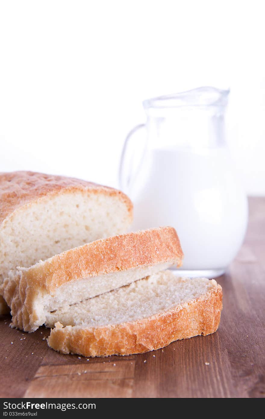 Fresh cooking bread with the jug of a milk. Fresh cooking bread with the jug of a milk