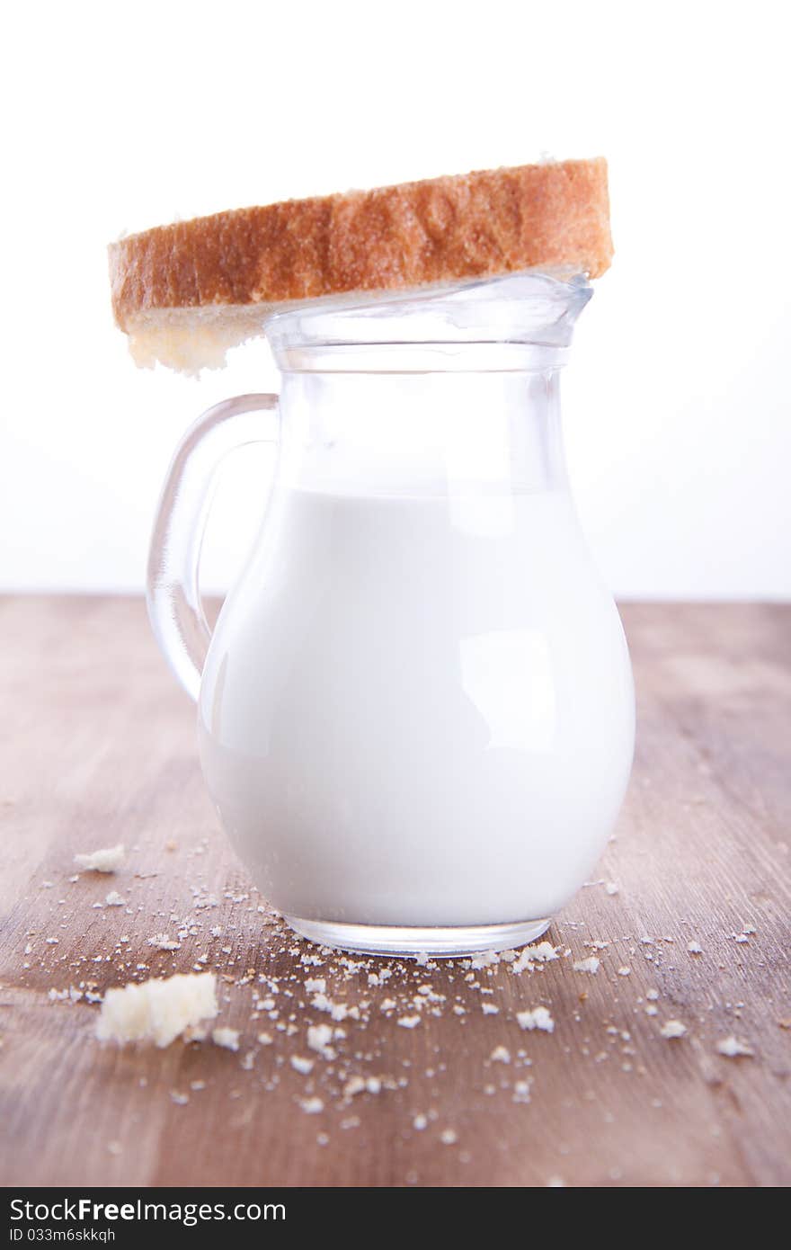 Fresh cooking bread with the jug of a milk. Fresh cooking bread with the jug of a milk