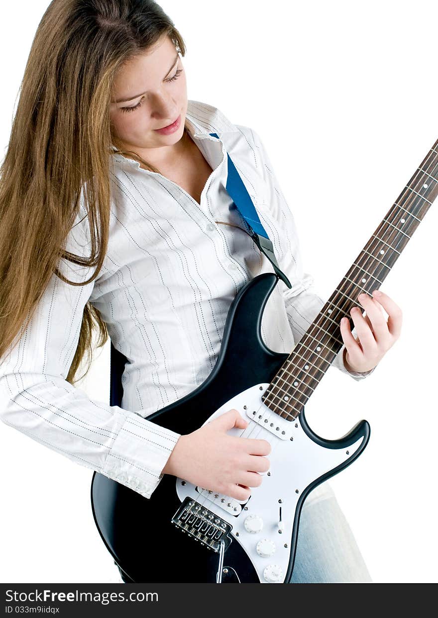 Teen girl holding a guitar like a rock star