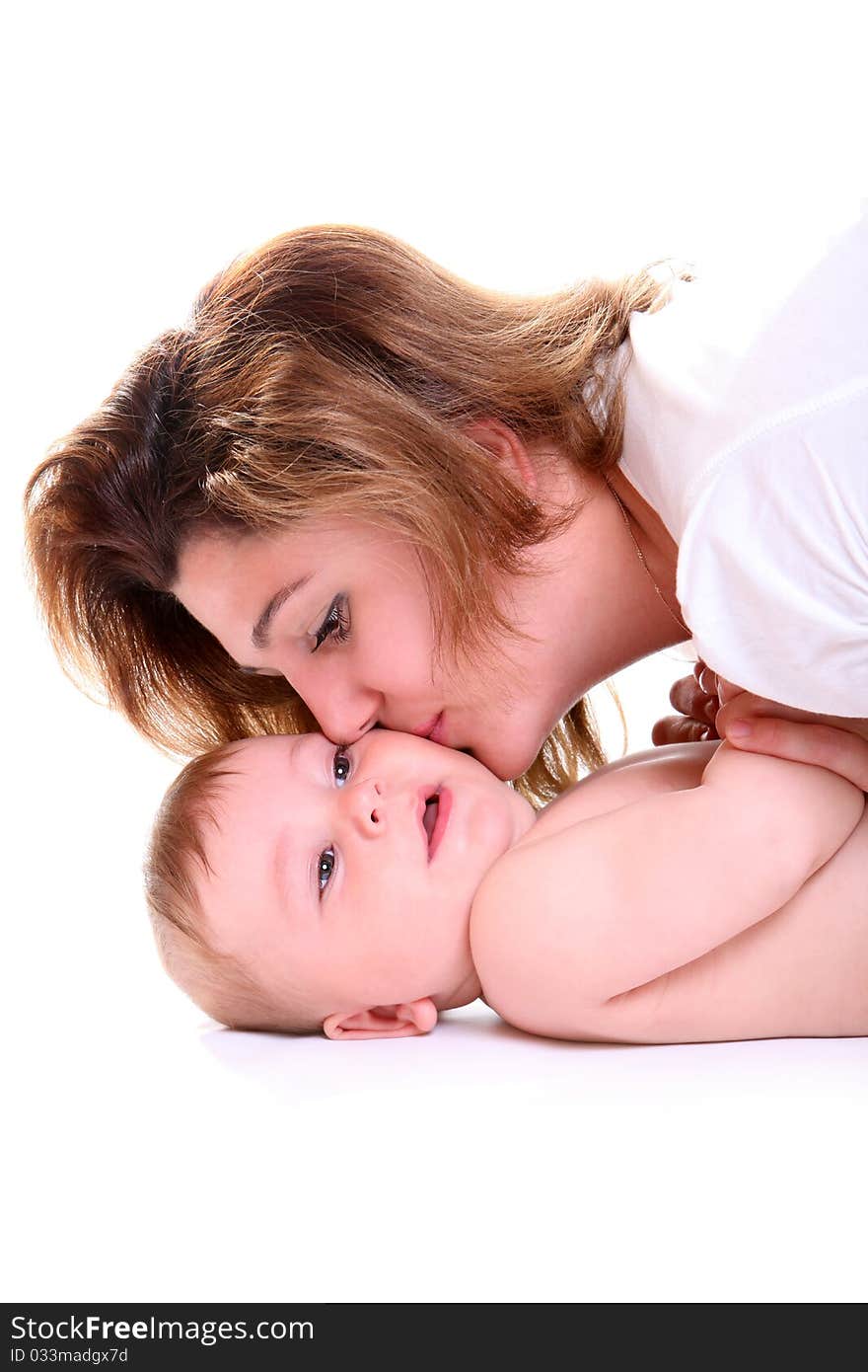 Happy young mother kissing a baby