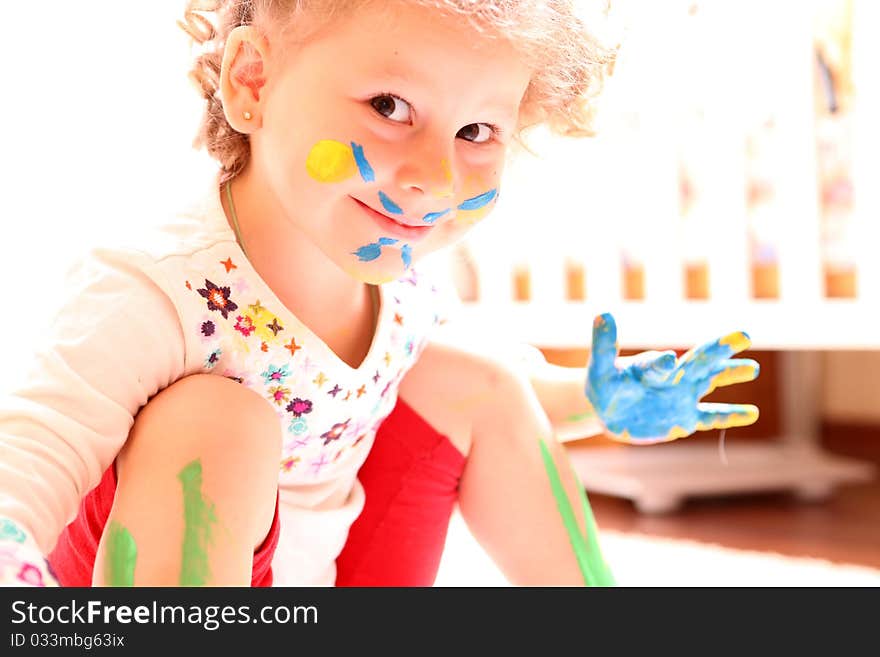 Girl with paint hands isolated on white