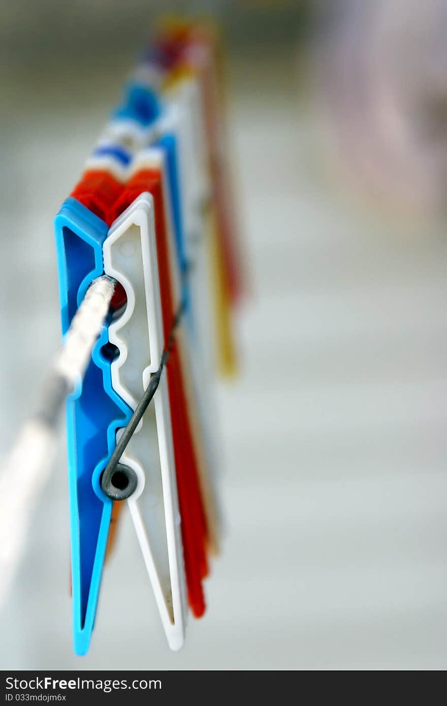 Colorful clothespin hanging on a closthesline with nicely blurred background. Colorful clothespin hanging on a closthesline with nicely blurred background.